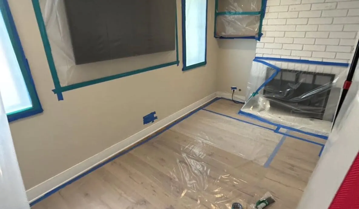 Crestline technician drying a living room with containment and air movers